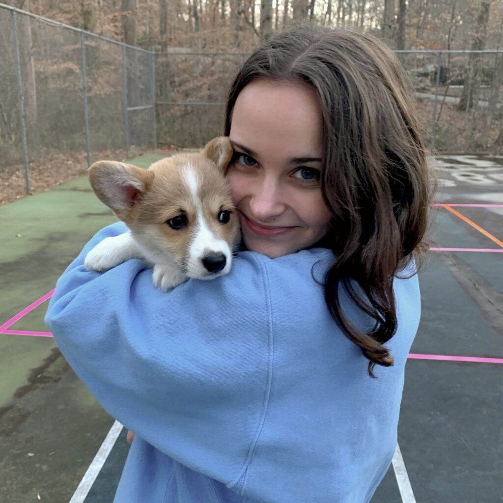 Hallie with a corgi puppy