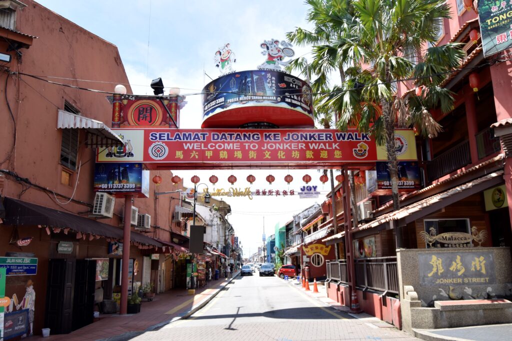 entrance to jonker street with palm trees and red lanterns